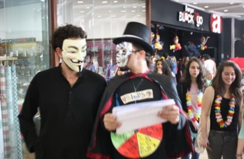 Masked men join superheroes protest in Tel Aviv