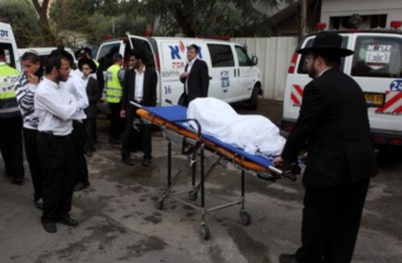 Religious authorities prepare bodies for burial 