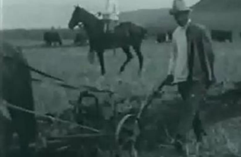 One-armed man plowing behind a horse