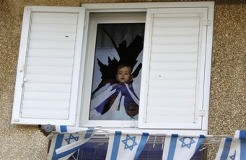 Baby in window of Netivot home damaged by Grad 