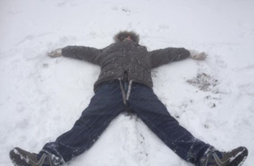 A student makes a snow-angel in Safed 390