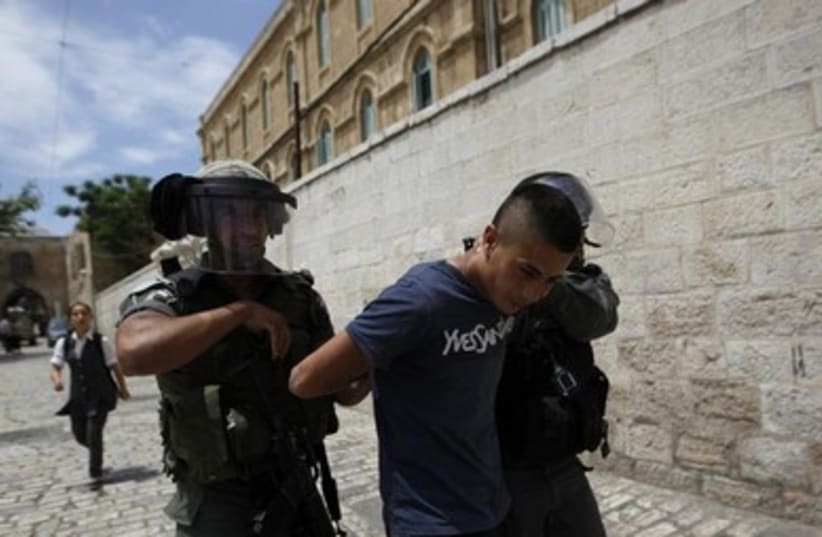 Israeli border police arrest a Palestinian youth in Jlem 390