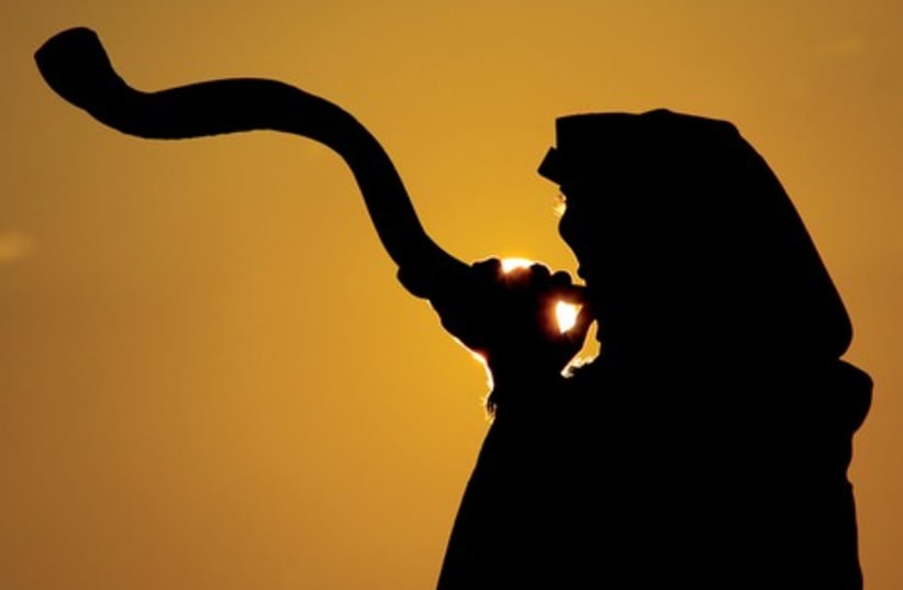 A man sounds a Kudo-horn shofar