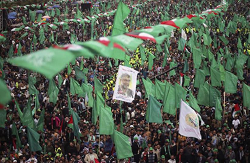 Hamas supporters attend a massive rally in Gaza‏