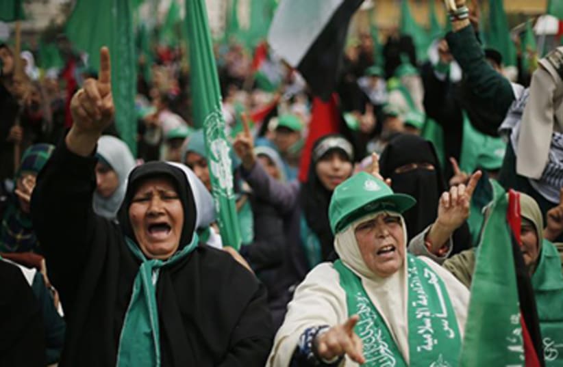 Hamas supporters attend a massive rally in Gaza‏