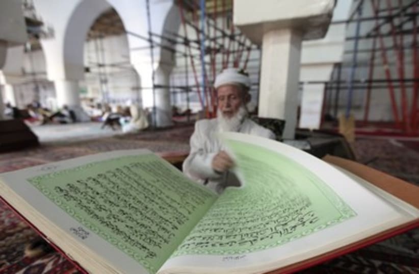 A man reads the Koran in a mosque in Sanaa, as Muslims prepare for the fasting month of Ramadan.