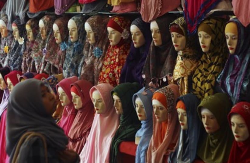 A woman shops for clothing ahead of the upcoming holy fasting month of Ramadan in Medan, North Sumatra.