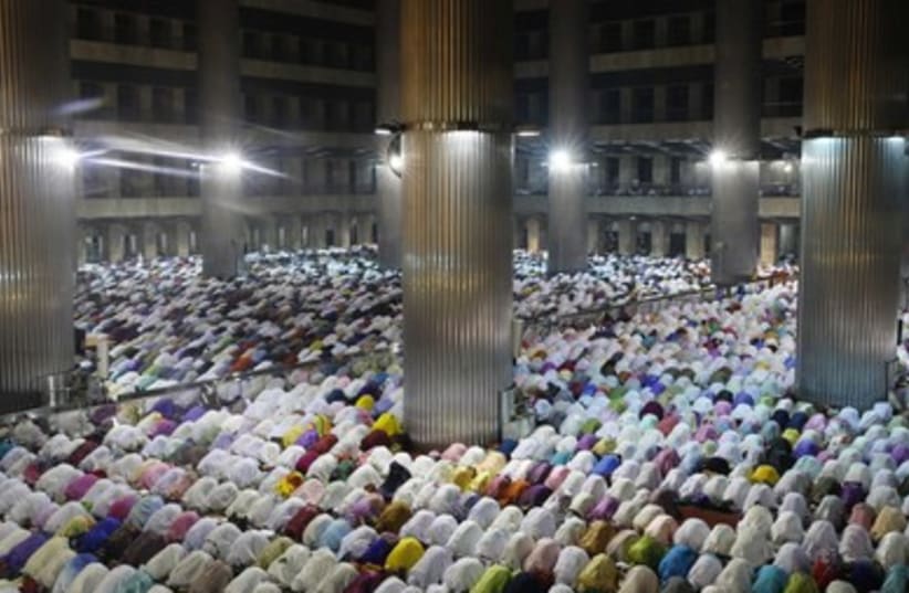 Muslims attend an evening mass prayer session called ''tarawih'' to mark the holy fasting month of Ramadan at Istiqlal Mosque in Jakarta. 