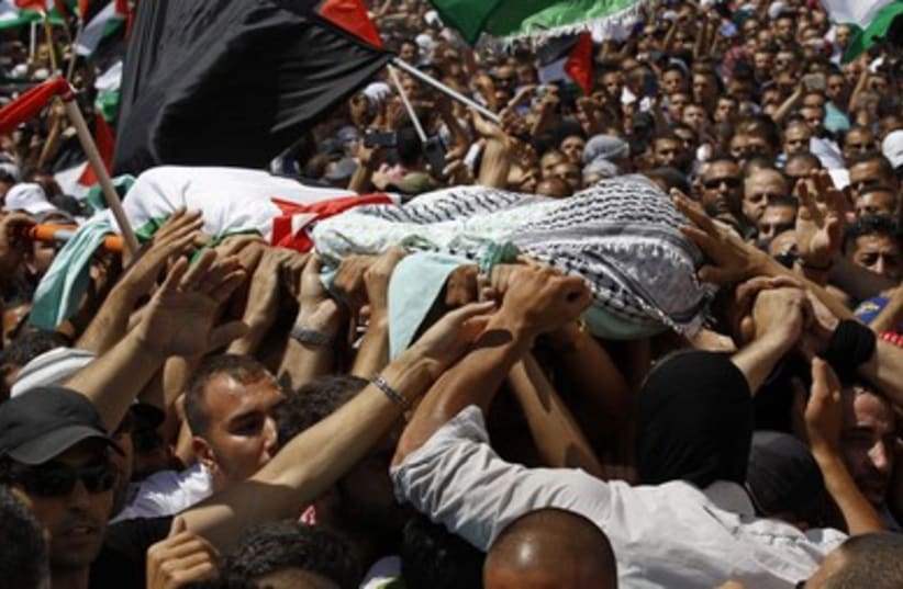 Palestinians carry the body of 16-year-old Muhammad Abu Khdeir in Shuafat.