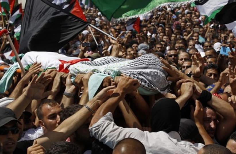 Palestinians carry the body of Mohammed Abu Khdeir during his funeral in Shuafat