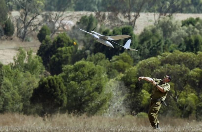 An Israeli soldier launches a Skylark unmanned aerial vehicle near the border with Gaza Strip