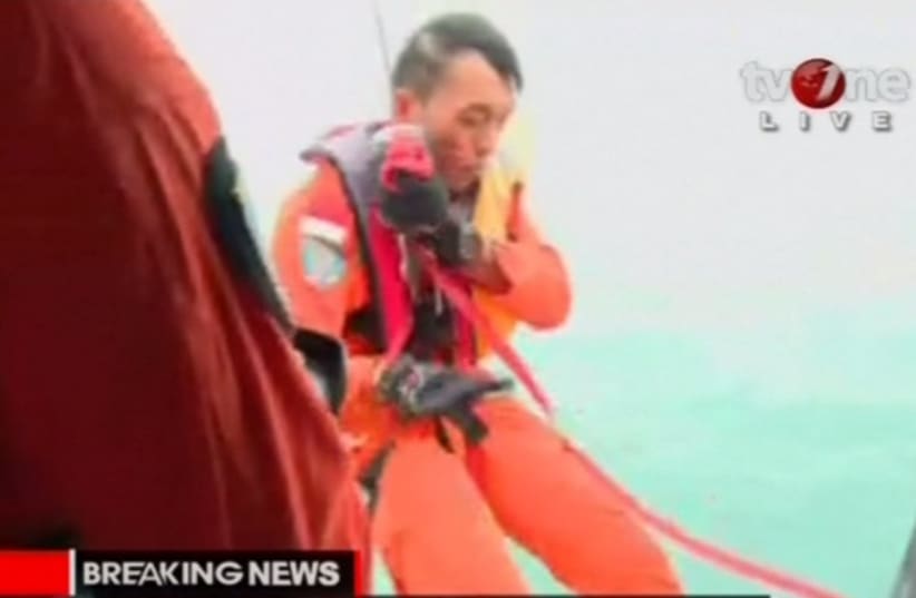 Indonesia's TV One shows a body found during the search for an AirAsia plane.