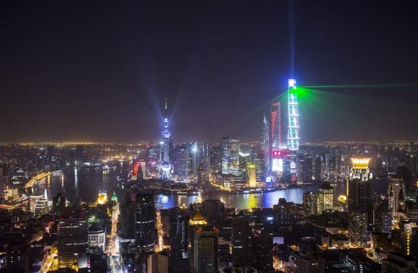 Light and laser illuminate the Lujiazui financial district of Pudong in Shanghai during a light show as part of a New Year countdown celebration