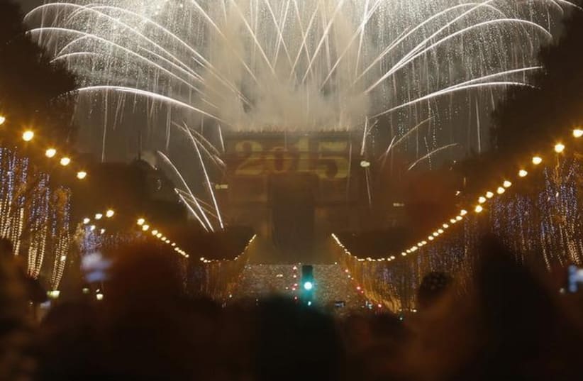 Fireworks light the sky over the Arc de Triomphe on the Champs Elysees Avenue in Paris