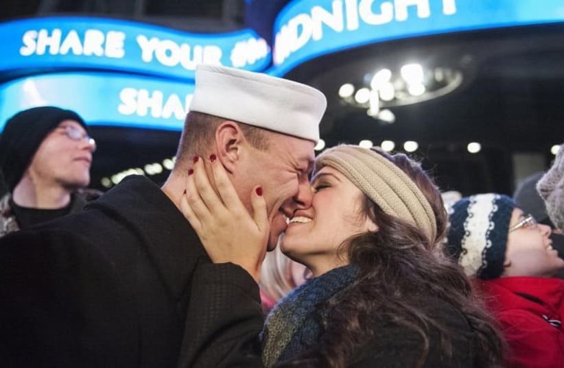 Ryan Silipino kisses his girlfriend Lisa Jacobs during New Year's Eve celebrations in Times Square, New York