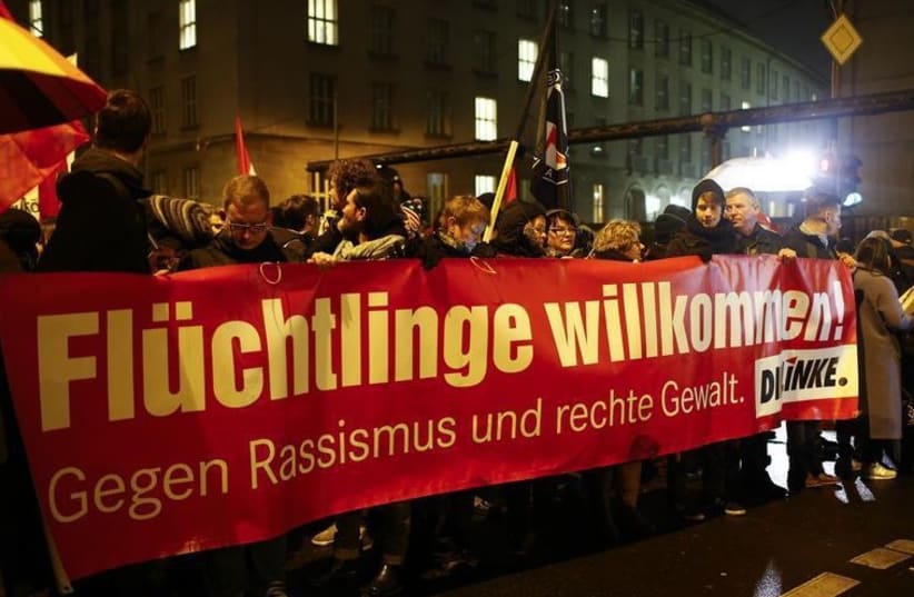 Members of the Left party (Die Linke) take part in a protest against the march of a grass-roots anti-Muslim movement in Berlin