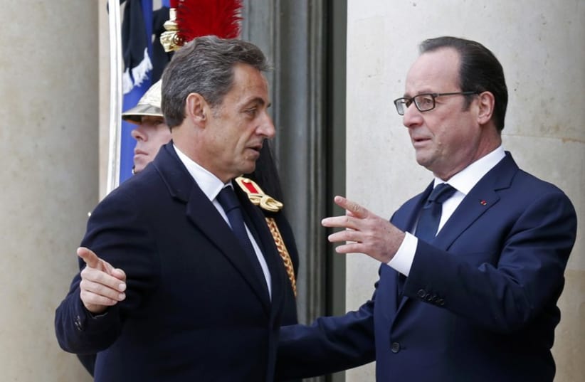 French President Francois Hollande welcomes former French President Nicolas Sarkozy at the Elysee Palace