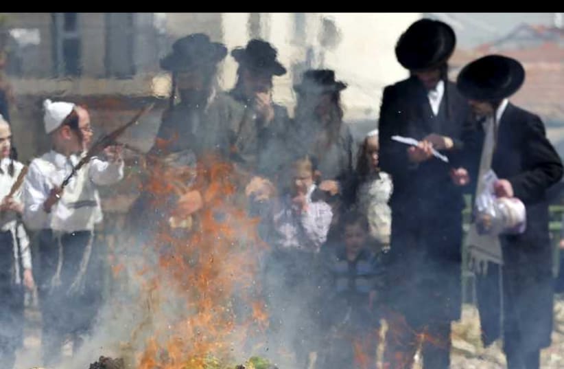 Ultra-Orthodox men burn leaven in Jerusalem ahead of Passover, April 3, 2015