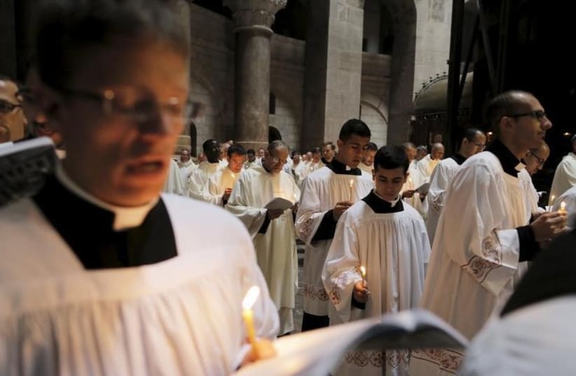 Members of the clergy take part in the Washing of the Feet ceremony in the Church of the Holy Sepulchre in Jerusalem's Old City