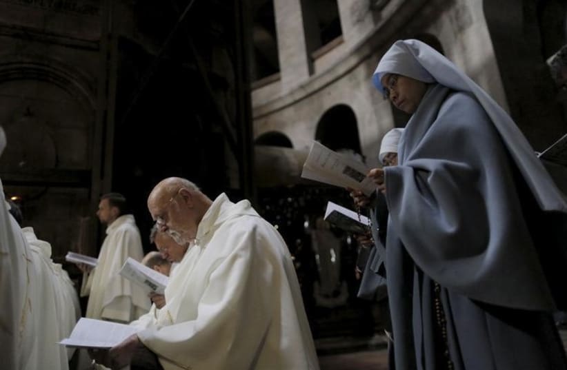 Catholic nuns and members of the clergy take part in the Washing of the Feet ceremony in the Church of the Holy Sepulchre in Jerusalem's Old City during Holy Week