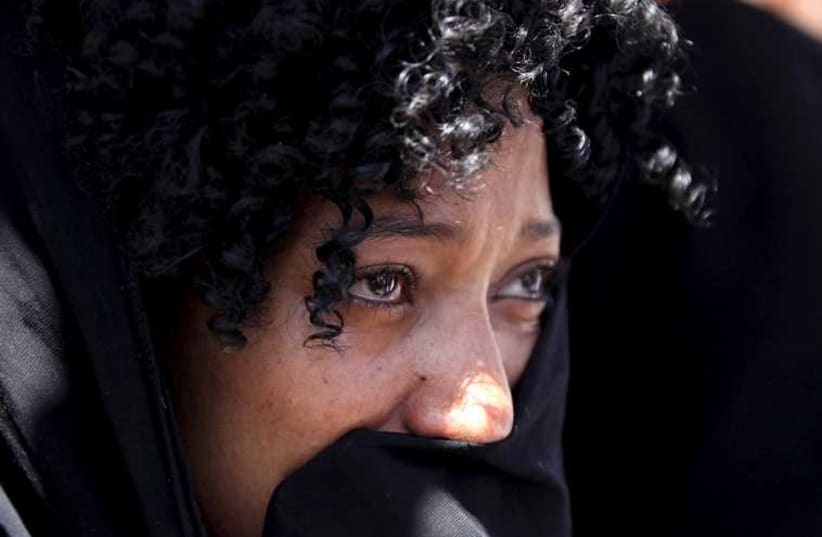 A woman mourns at the home of one of the 30 Ethiopian victims killed by members of the militant Islamic State in Libya, in the capital Addis Ababa