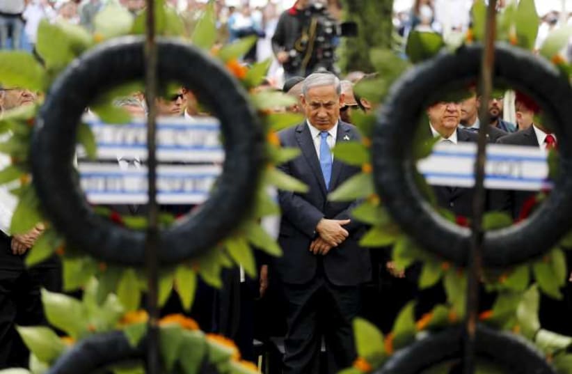 Netanyahu stands during a Remembrance Day ceremony at Mount Herzl military cemetery in Jerusalem April 22, 2015.