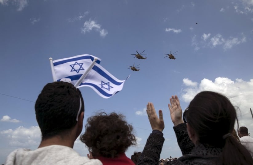 IAF planes fly during an aerial show over the Mediterranean Sea as seen from a Tel Aviv beach, as part of Independence Day celebrations, April 23, 2015