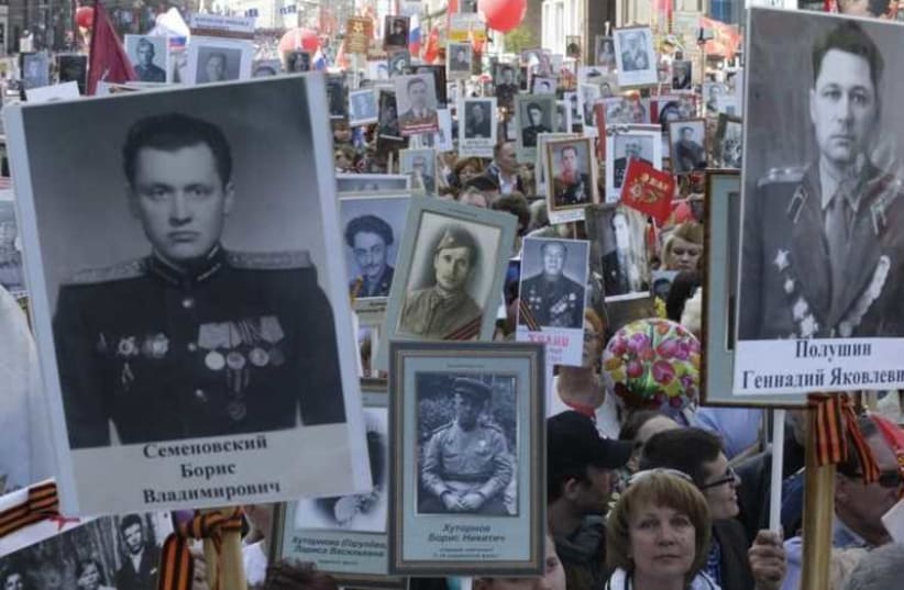 People hold pictures of World War Two soldiers as they take part in the Immortal Regiment march during the Victory Day celebrations in central Moscow