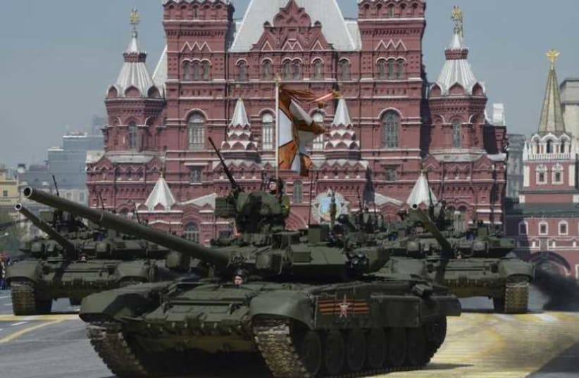 Russian T-90A main battle tanks drive during the Victory Day parade at Red Square in Moscow