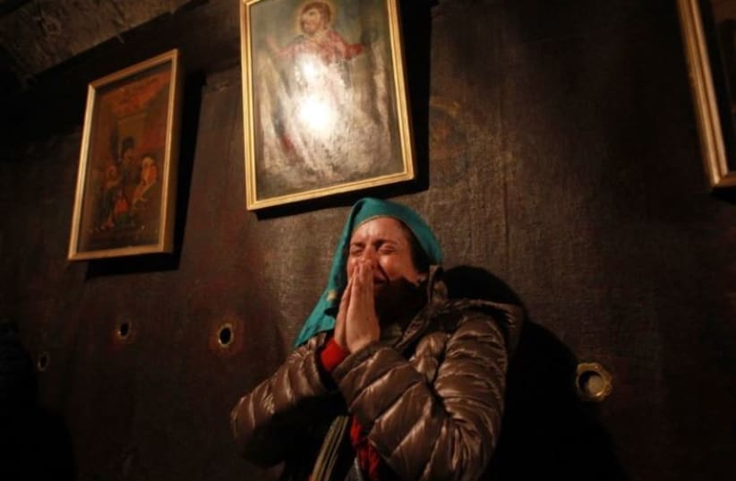 A Christian worshiper prays inside the Grotto at the Church of the Nativity, believed to be the birthplace of Jesus Christ, in the West Bank biblical town of Bethlehem
