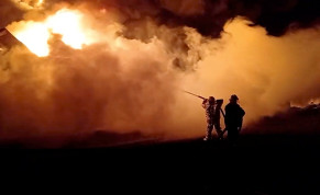  Fire fighters extinguish fire in an oil depot that Ukraine's State Emergency Services say was caused by Russian strikes in Zhytomyr region, Ukraine March 7, 2022 in this still image obtained from a handout video.