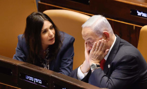  Israeli Prime Minister Benjamin Netanyahu is seen sitting with his face in his hands next to Transportation Minister Miri Regev in the Knesset plenum in Jerusalem, on February 20, 2023.